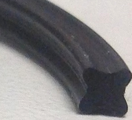An X-Ring cut to show the X shaped cross section.
